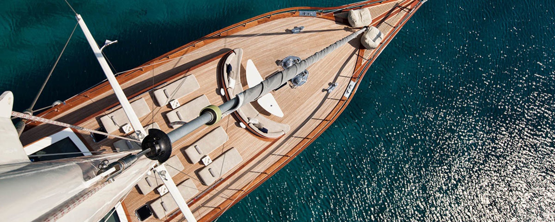 A wooden sailing ship sails on the open sea - bird's-eye view.