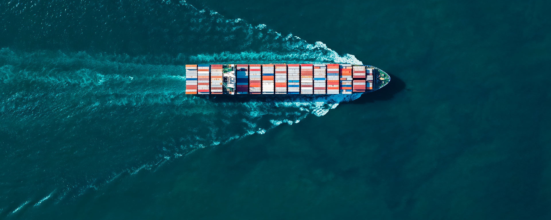 Aerial view of a container ship transporting global cargo across the ocean