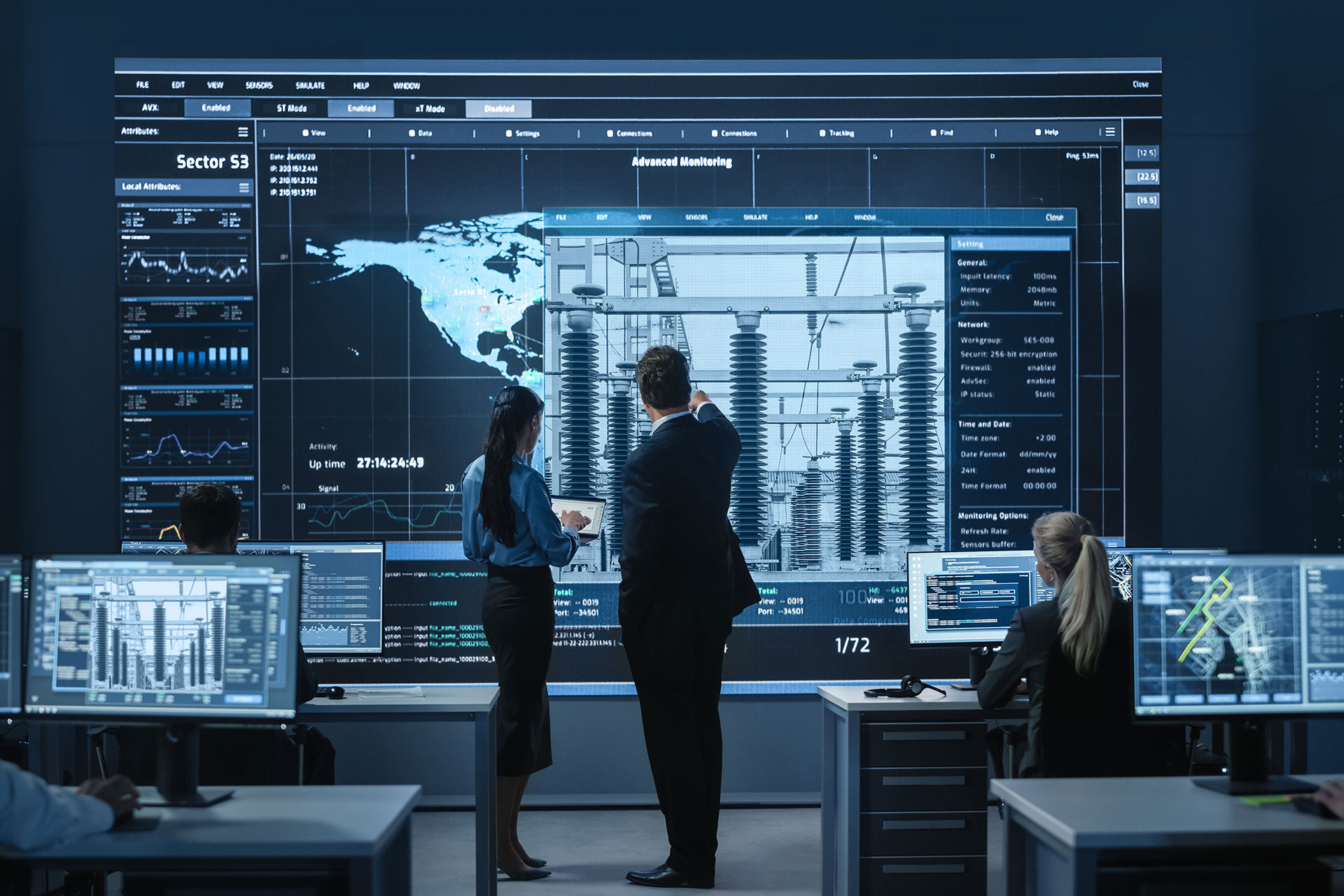Control room with analysts monitoring real-time data and advanced systems on large screens